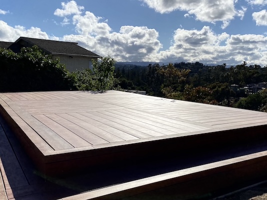 Freshly installed large deck that is well illuminated.
