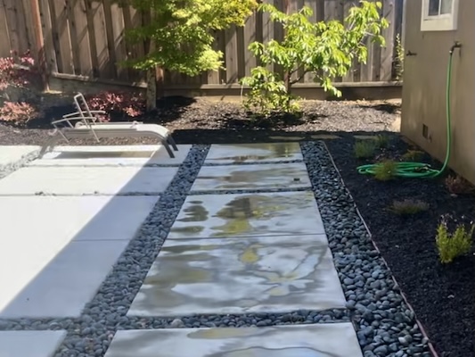 Video of a freshly installed walkway with flagstone and gravel.